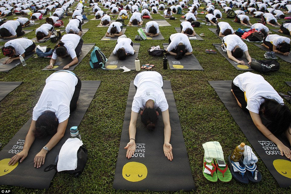 Participants rest in Child's Pose in Kuala Lumpur on June 21, the first celebration of the day 