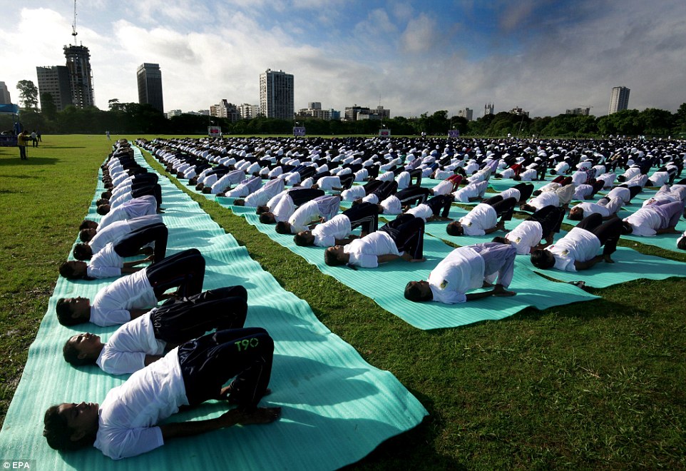 Thousands of Indian National Cadet Corps (NCC) boys and girls participate in a mass yoga session near Victoria Memorial in Calcutta