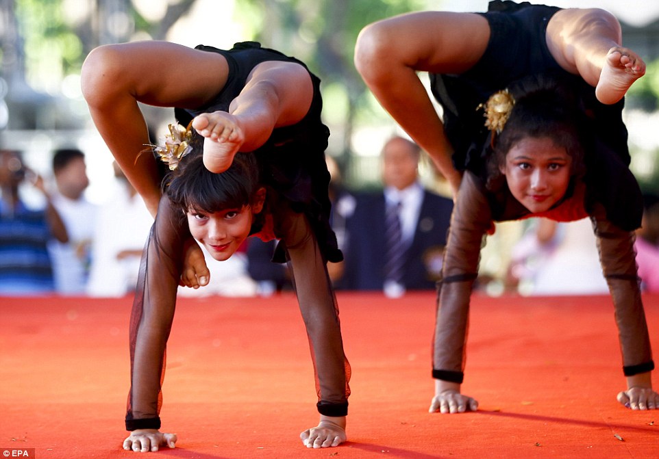 Young Indian yoga students are seen here performing in Bangkok, Thailand, in honour of the day