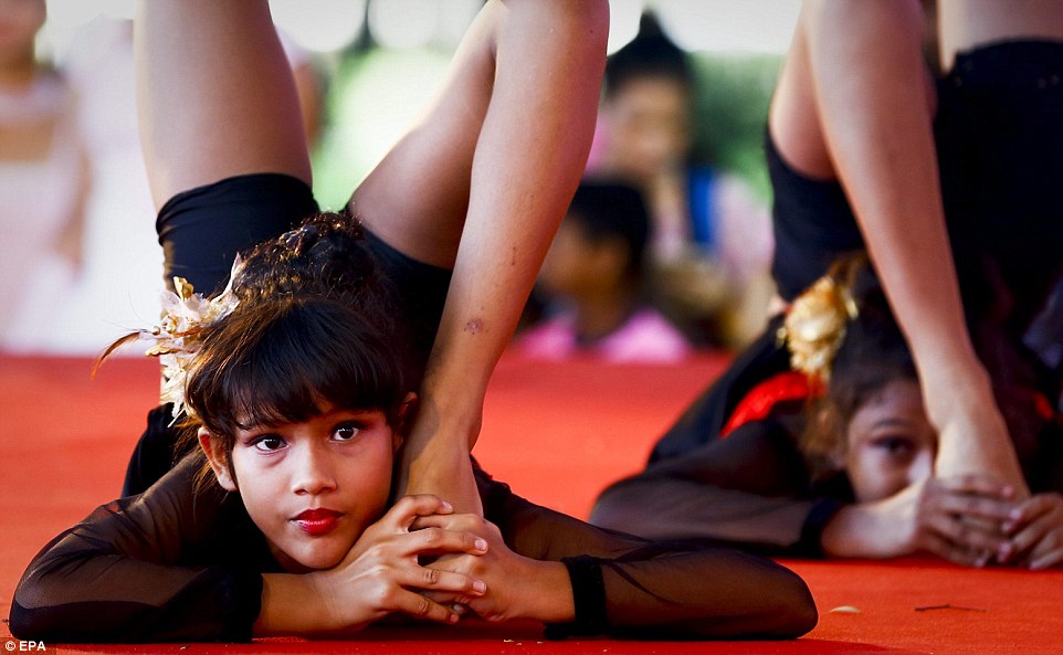 Yoga students from India perform onstage on the occasion of the first International Day of Yoga in Bangkok, Thailand