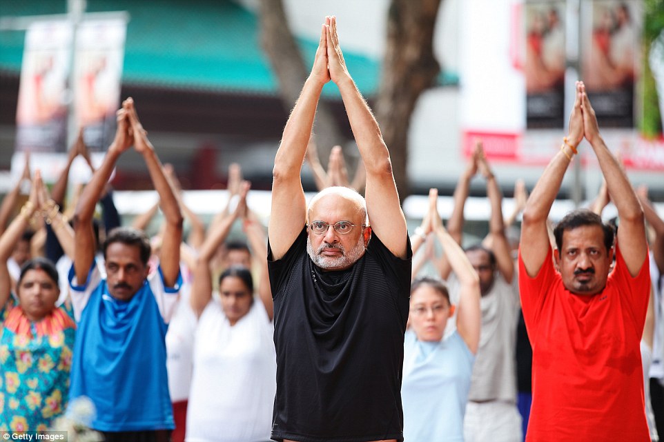 Piyush Gupta (centre), chief executive officer of DBS Group Holdings Ltd, takes part in a yoga session in Singapore