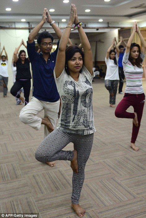 Nepalese people take part in a yoga session in Kathmandu