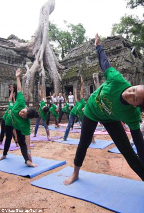 Participants practice among the ancient ruins of Angkor Wat in Siem Reap, Cambodia
