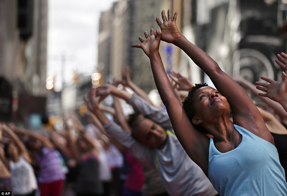 Yoga instructor Tracye Warfield, right, participates in a yoga class in Times Square