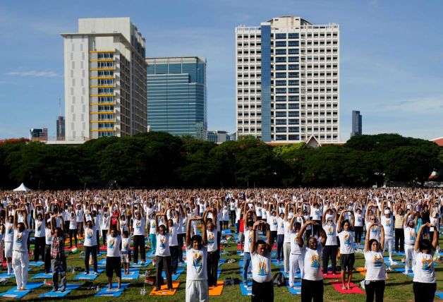 Thousands of people participate in a yoga exercise at Chulalongkorn University field, marking the International Day of Yoga in Bangkok, Thailand, Sunday, June 21, 2015.  India's Prime Minister Narendra Modi called for a day dedicated to yoga when he addressed the annual United Nations General Assembly in September, 2014. A resolution in support, co-sponsored by a record 177 countries, was adopted by the Assembly on  Dec. 11, 2014. Photo: Sakchai Lalit, AP / AP
