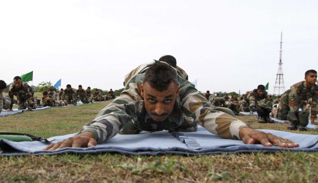 Indian army soldiers perform yoga at an army training area, in Chennai, India, Sunday, June 21, 2015. Millions of yoga enthusiasts across the world bent and twisted their bodies in complex postures Sunday to mark International Yoga Day.. Photo: Arun Sankar K, AP / AP