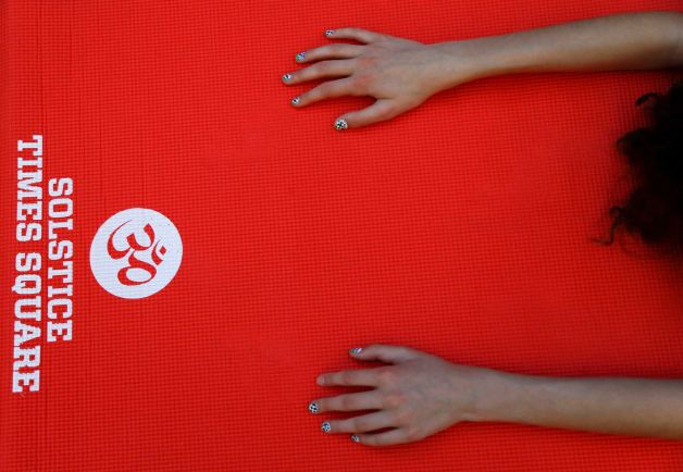 A yogi stretches out on a mat during the 13th annual Solstice in Times Square event, Sunday, June 21, 2015, in New York. Several thousand yogis participated in the event to mark the summer solstice. Photo: Julie Jacobson, AP / AP