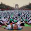 Indian Prime Minister Narendra Modi, center front, lies down on a mat as he performs yoga along with thousands of Indians on Rajpath, in New Delhi, India, Sunday, June 21, 2015. Millions of yoga enthusiasts are bending their bodies in complex postures across India as they take part in a mass yoga program to mark the first International Yoga Day.